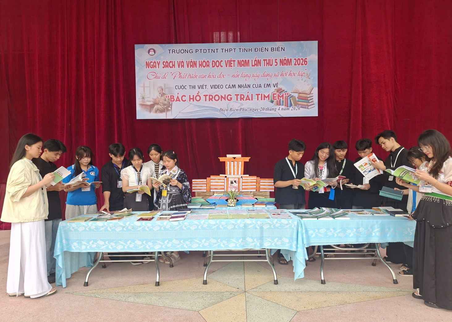 ''A group of people standing around a table

Description automatically generated''