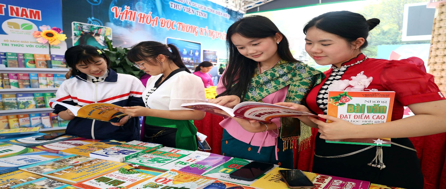 'A group of women looking at a book
Description automatically generated'