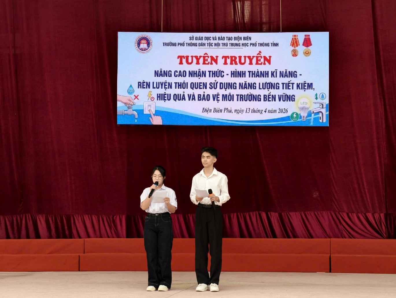 'A couple of people on a stage

Description automatically generated'